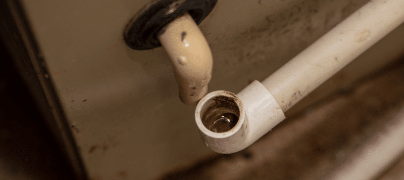 Close-up of a clogged or dirty HVAC condensate drain line