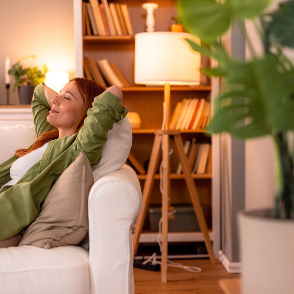 Homeowner relaxing comfortably on a couch in a climate-controlled living room
