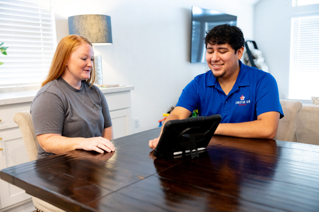 Lonestar Air Services technician discussing HVAC options with a homeowner